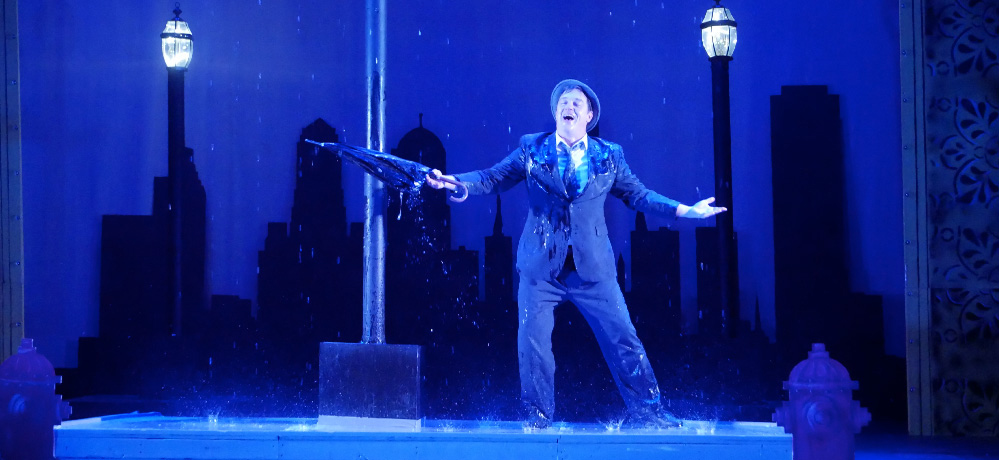 stage setup with man singing in rain